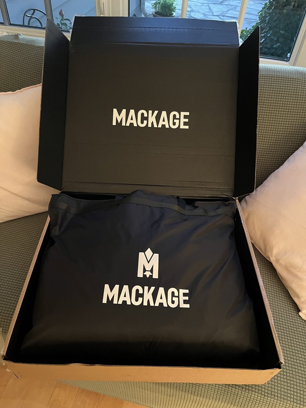 The Mackage Moritz-X as it arrived — open box with the branded dust bag inside