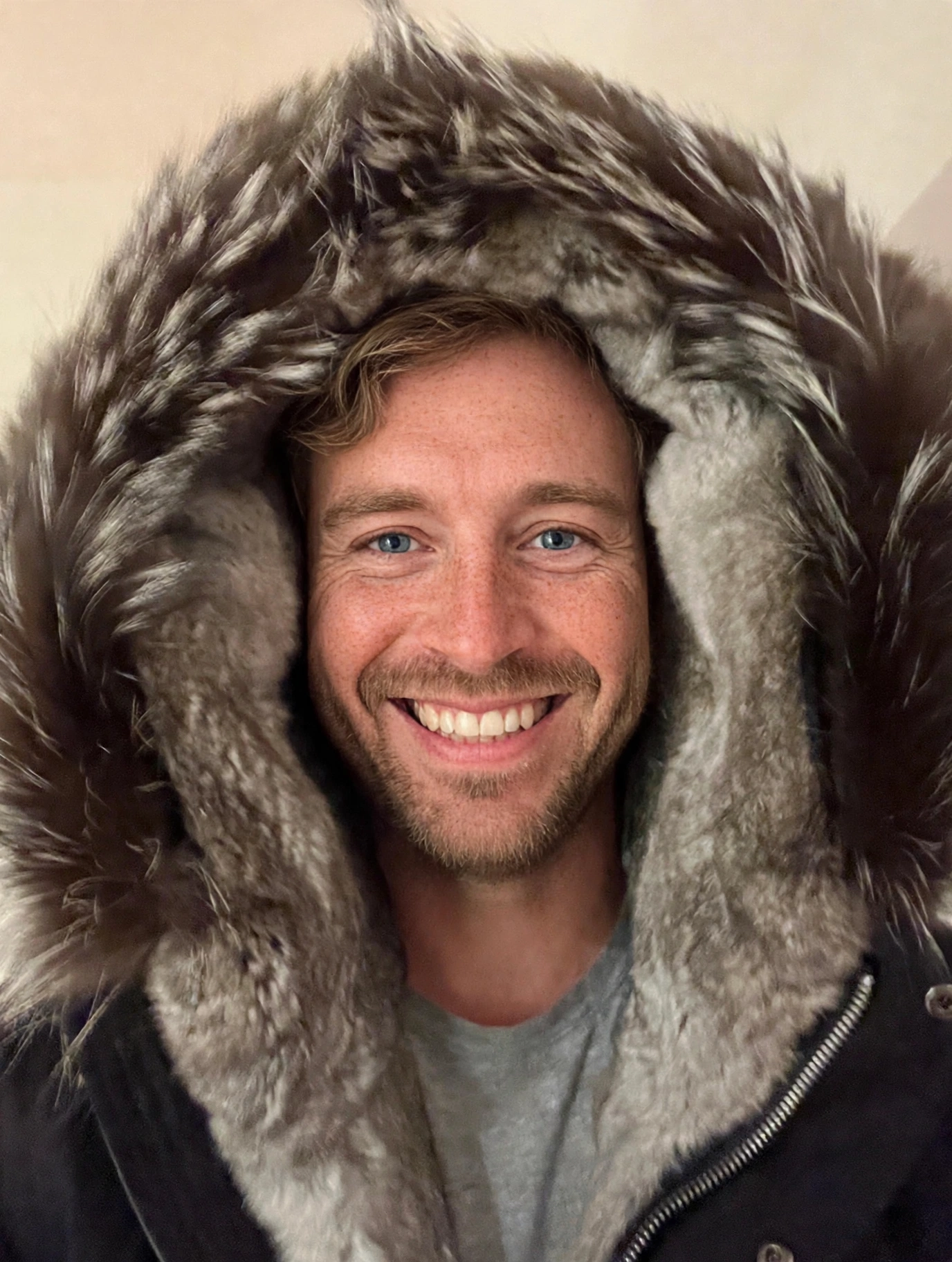 The Mackage Moritz-X Parka worn with the hood up — silver fox fur trim framing the rabbit fur lining